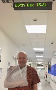 Colin with temporary sling in hospital corridor