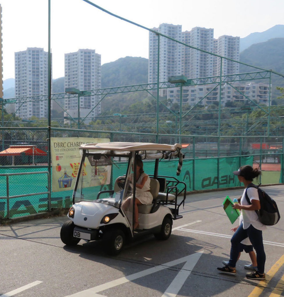 Ferrari-price golf buggy: Buggy drives past the tennis courts
