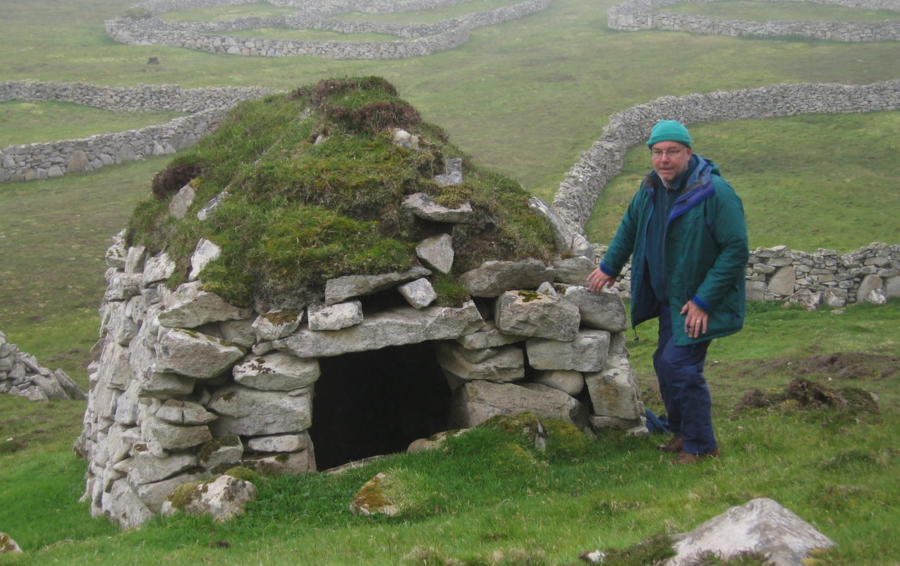 St Kilda: Colin next to one of the black houses on Hirta