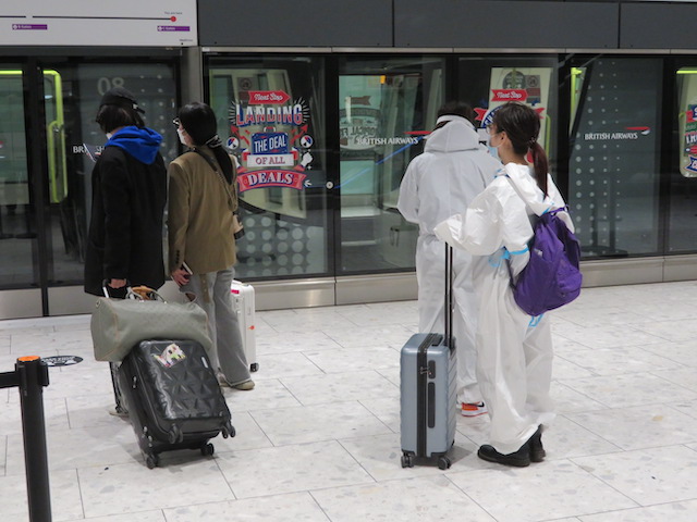 Travellers in hazmat suits