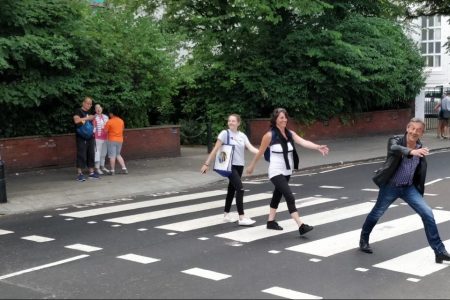 Tourists stride across the fabled Abbey Road crossing